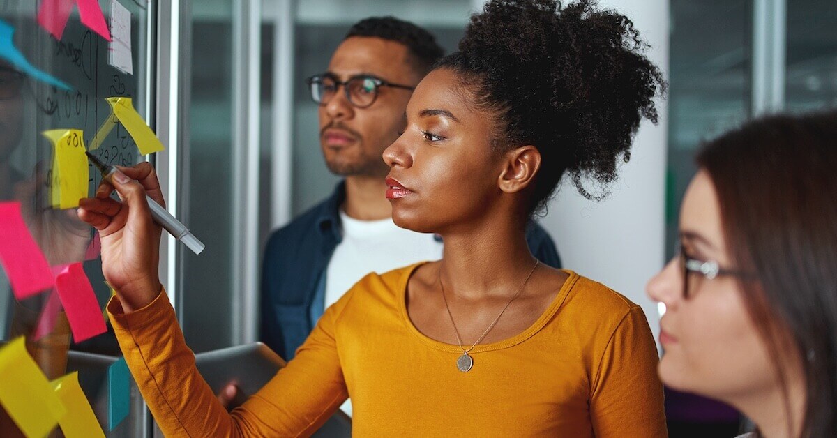 Two sales managers review the results of a sales skills assessment.