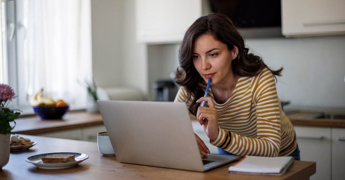 A saleswoman studies a new skill online.