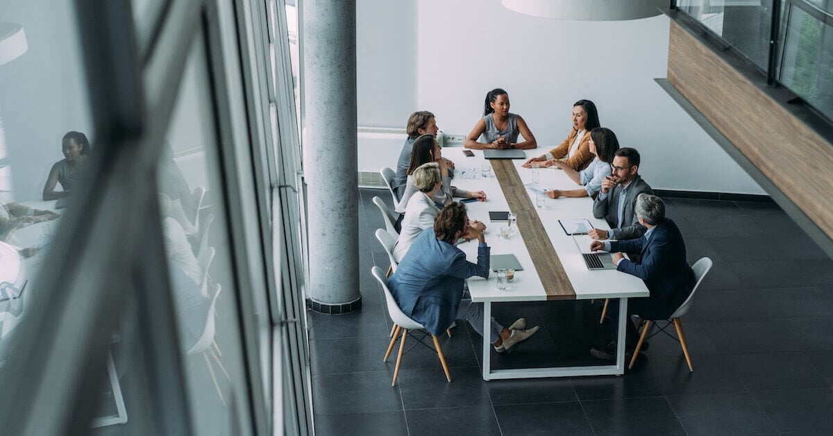 A sales manager begins a meeting with her team.